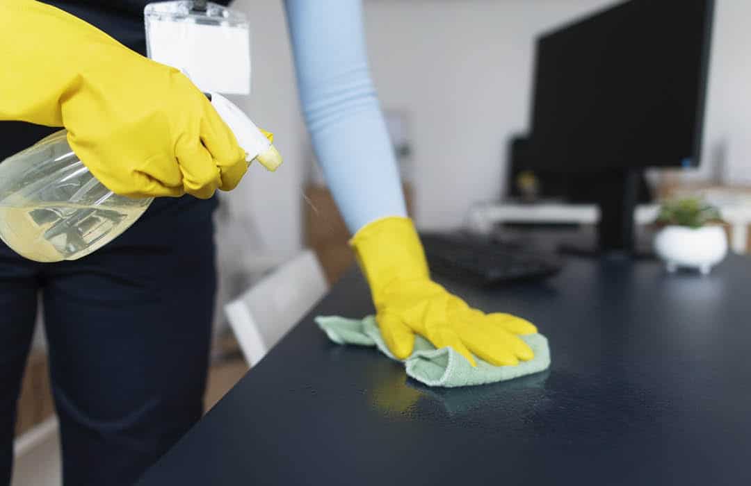 Professional Cleaning Services - Office Cleaning - A desk being wiped clean.