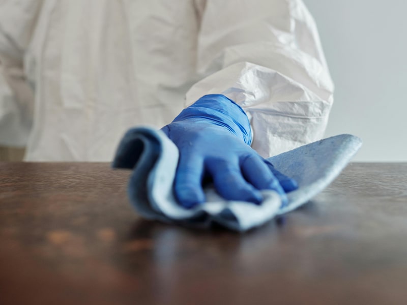 Cleaning surface wearing biohazard suit for protection